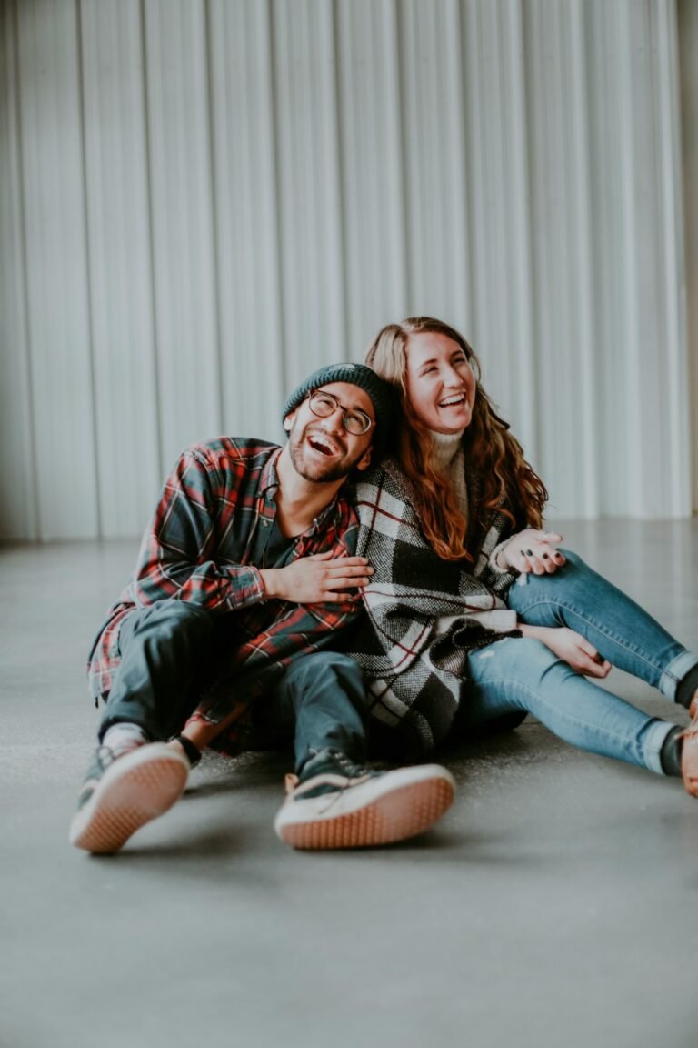 Smiling couple sitting close together, feeling emotionally safe