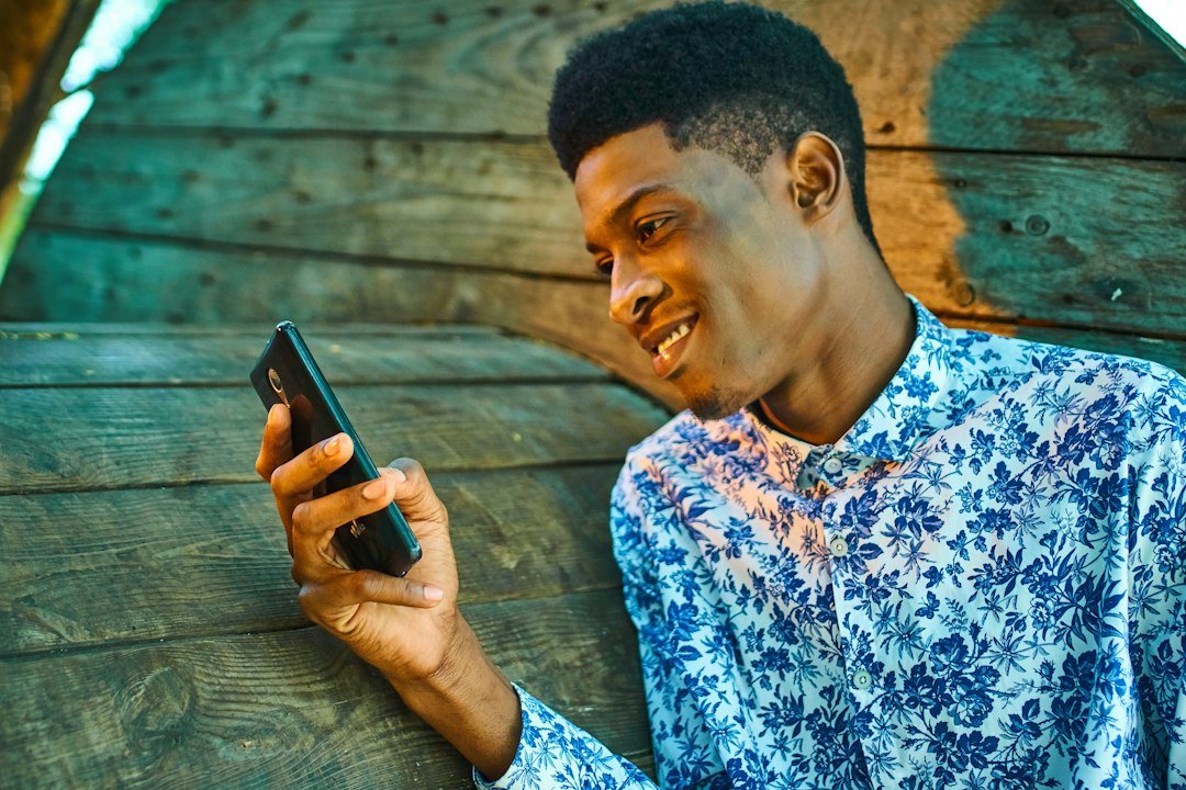 Man on his phone deciding how to text a girl after getting her number
