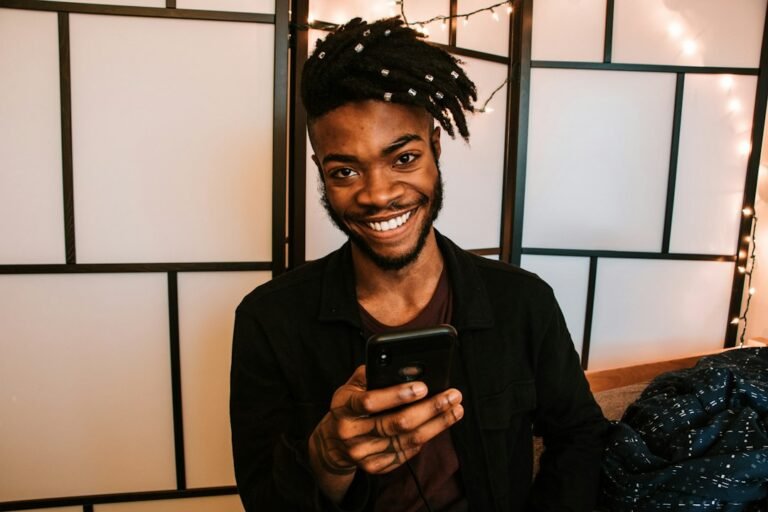 Smiling man texting on his phone