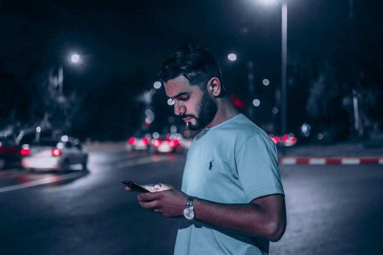 Man smiling while texting a girl he likes