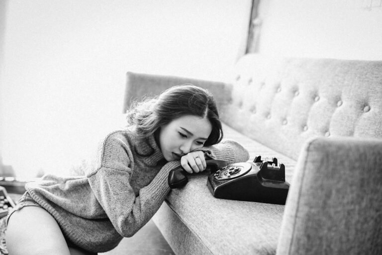 Woman sitting alone on the sofa, thinking about her relationship