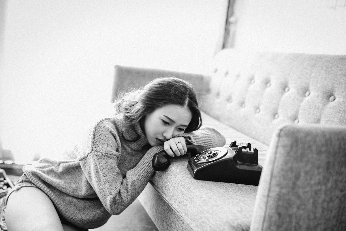 Woman sitting alone on the sofa, thinking about her relationship