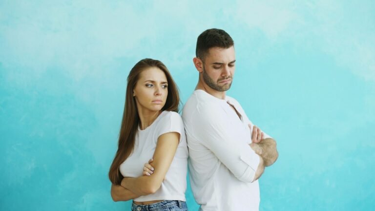 Couple standing back to back with arms crossed after an argument
